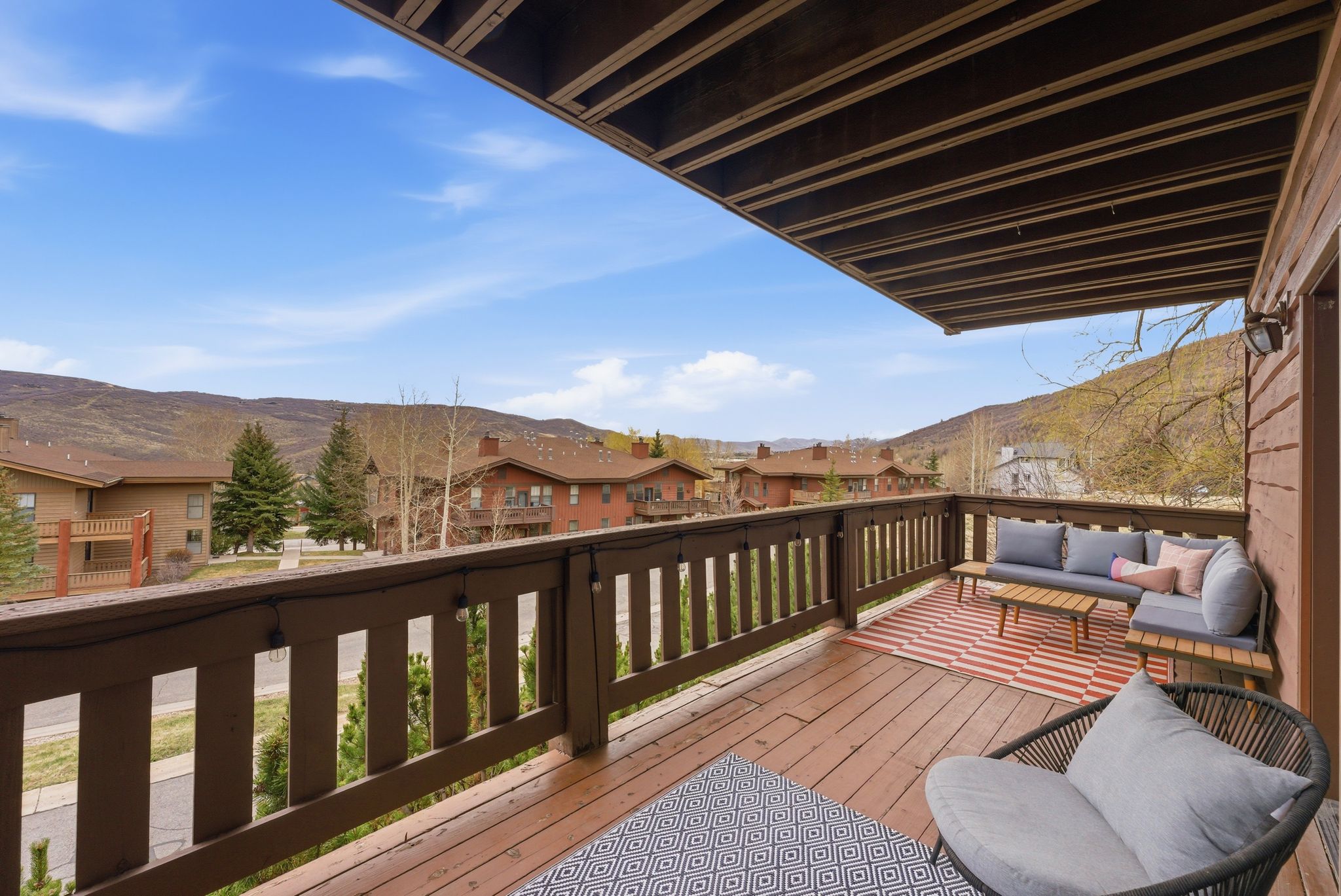 Deck with a residential view, outdoor seating, and a mountain view