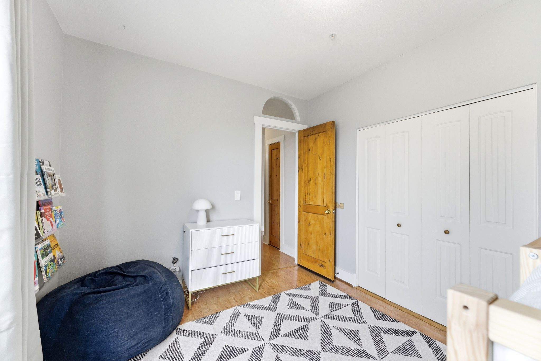 Bedroom with light wood-type flooring and a closet