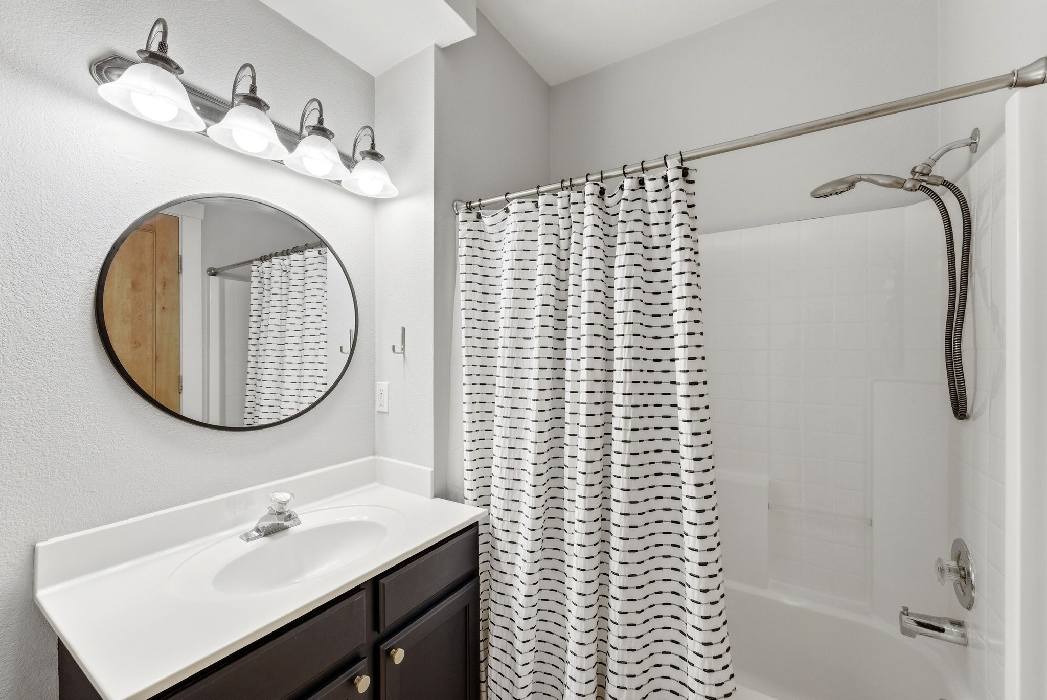 Bathroom featuring vanity and shower / bath combo
