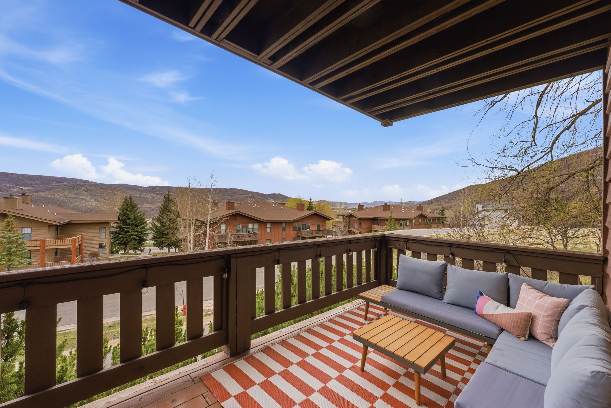 Wooden deck with a residential view, an outdoor lounge area, and a mountain view