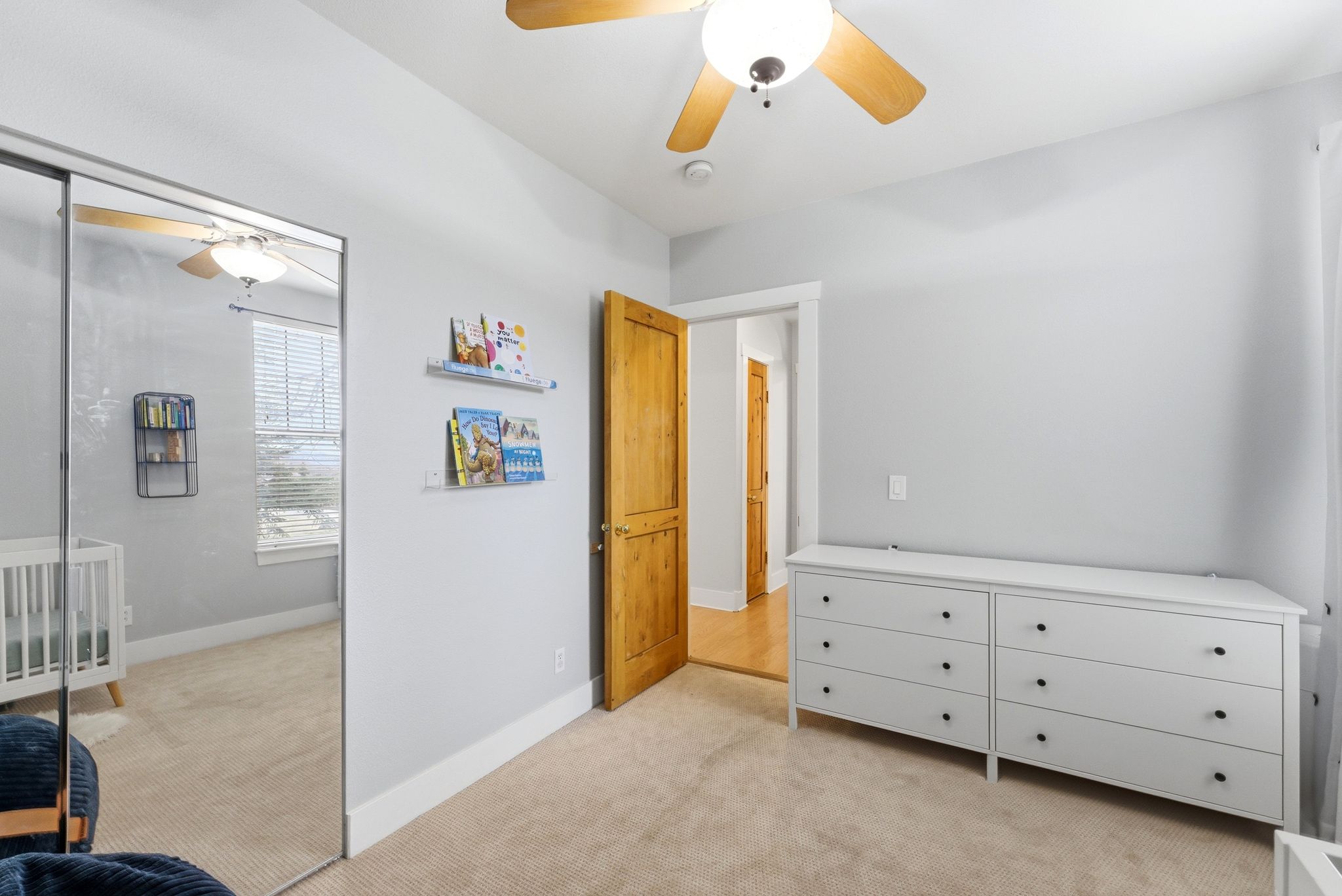Bedroom featuring light carpet, ceiling fan, and a closet