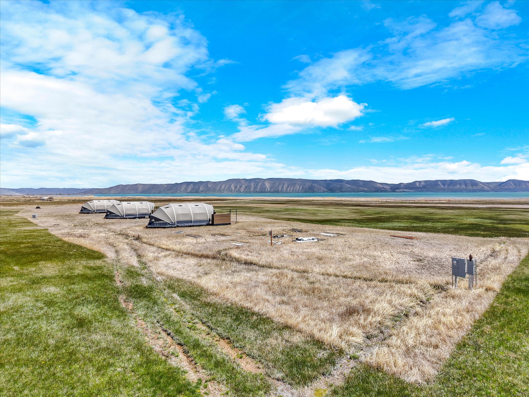 View of green lawn featuring a mountain view and a view of rural / pastoral area