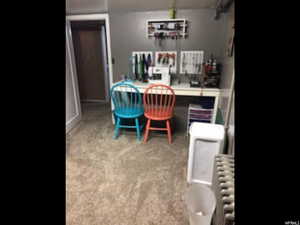 Home office with radiator and light carpet