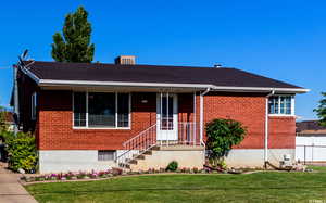 Ranch-style home with brick siding and a porch