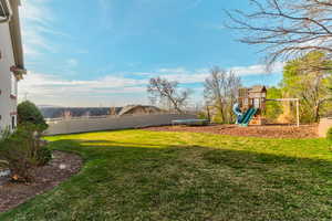 Fenced yard featuring a trampoline