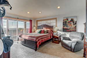 Carpeted bedroom featuring recessed lighting and access to exterior