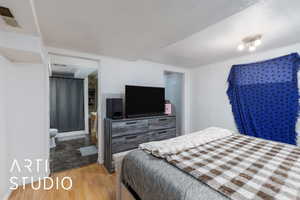 Bedroom featuring a textured ceiling and light wood-type flooring