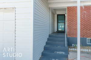 Entrance to property featuring brick siding
