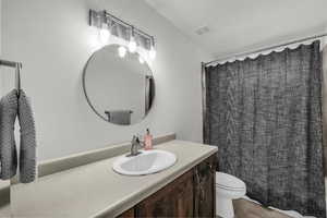 Bathroom featuring vanity and curtained shower