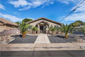 View of front of property featuring stucco siding, a tiled roof, and stone siding