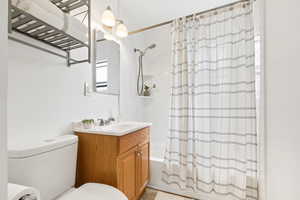 Bathroom featuring vanity and shower / bath combo with shower curtain