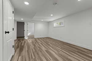 Unfurnished room with light wood finished floors and recessed lighting