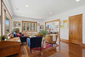 Main floor living room with hardwood floors and trim
