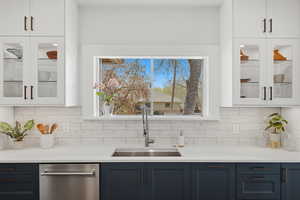 Open concept kitchen with large island, gas range, and wood floors