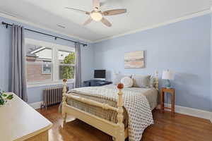 Main floor bedroom with wood floors