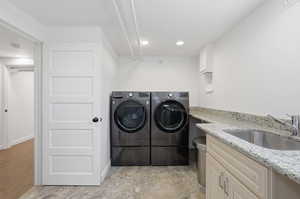 Large laundry room with utility sink and storage