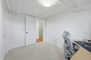 Office featuring light colored carpet and baseboards