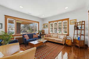 Main floor living room with hardwood floors and trim