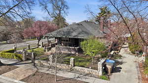 View of front of house with roof with shingles, a fenced front yard, and a gate