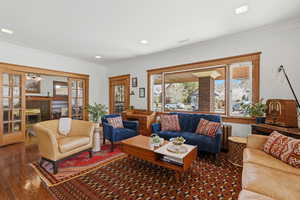 Main floor living room with hardwood floors and trim