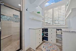 Walk in closet featuring light wood-type flooring
