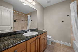 Full bath featuring vanity and shower / bath combination with curtain
