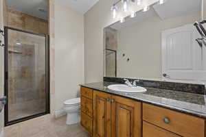 Bathroom with vanity, a stall shower, and light tile patterned floors