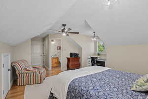 Bedroom featuring light wood-type flooring and connected bathroom