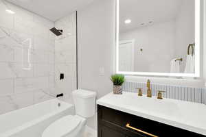 Bathroom with vanity and bathing tub / shower combination