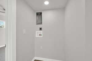 Laundry area featuring washer hookup, hookup for an electric dryer, and dark wood-style floors