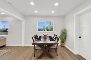 Dining room featuring light wood-style flooring and recessed lighting