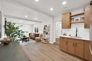 Living area featuring recessed lighting, light wood finished floors, and beamed ceiling