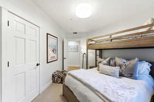 Bedroom featuring baseboards and light carpet