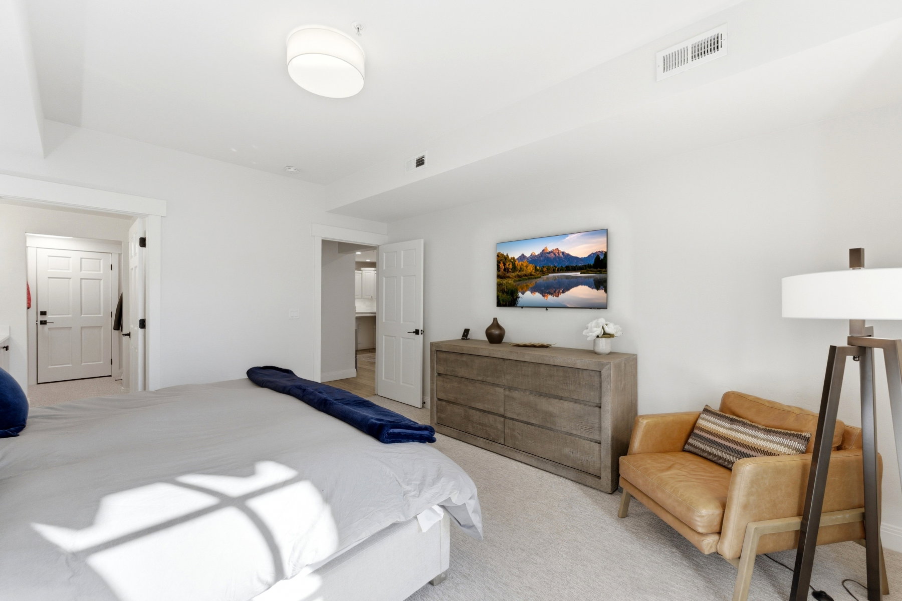 Bedroom featuring light colored carpet
