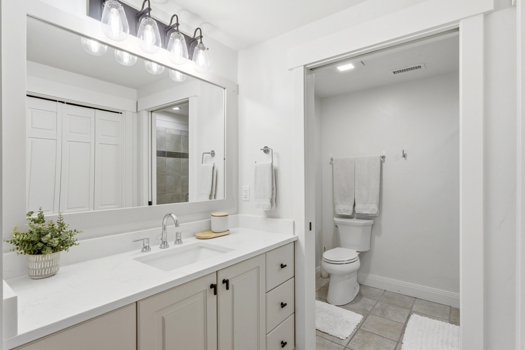 Full bath with vanity and a closet