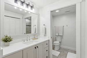 Full bath with vanity and a closet