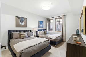 Bedroom featuring light carpet
