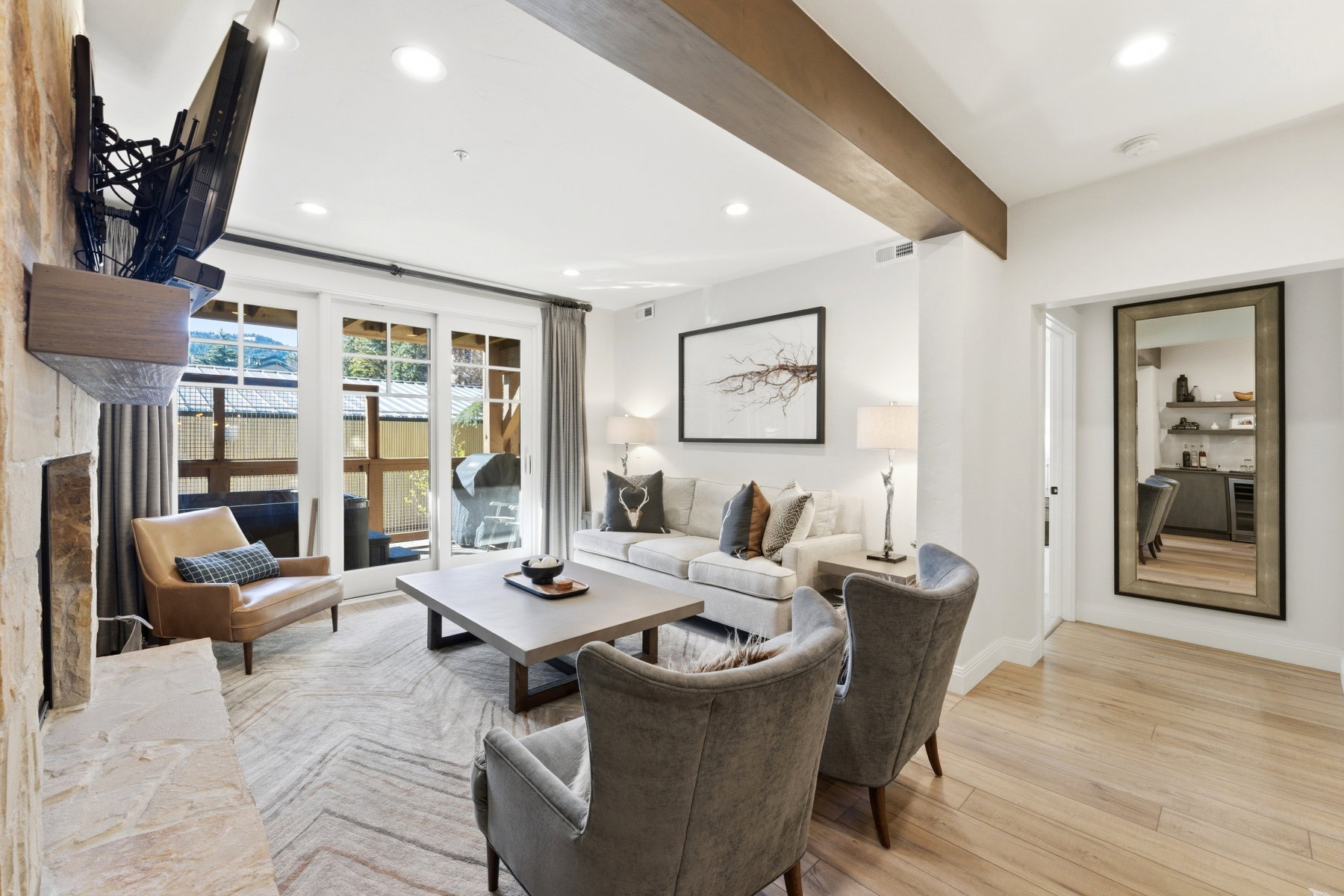 Living room featuring recessed lighting, light wood-style flooring, beam ceiling, and wine cooler