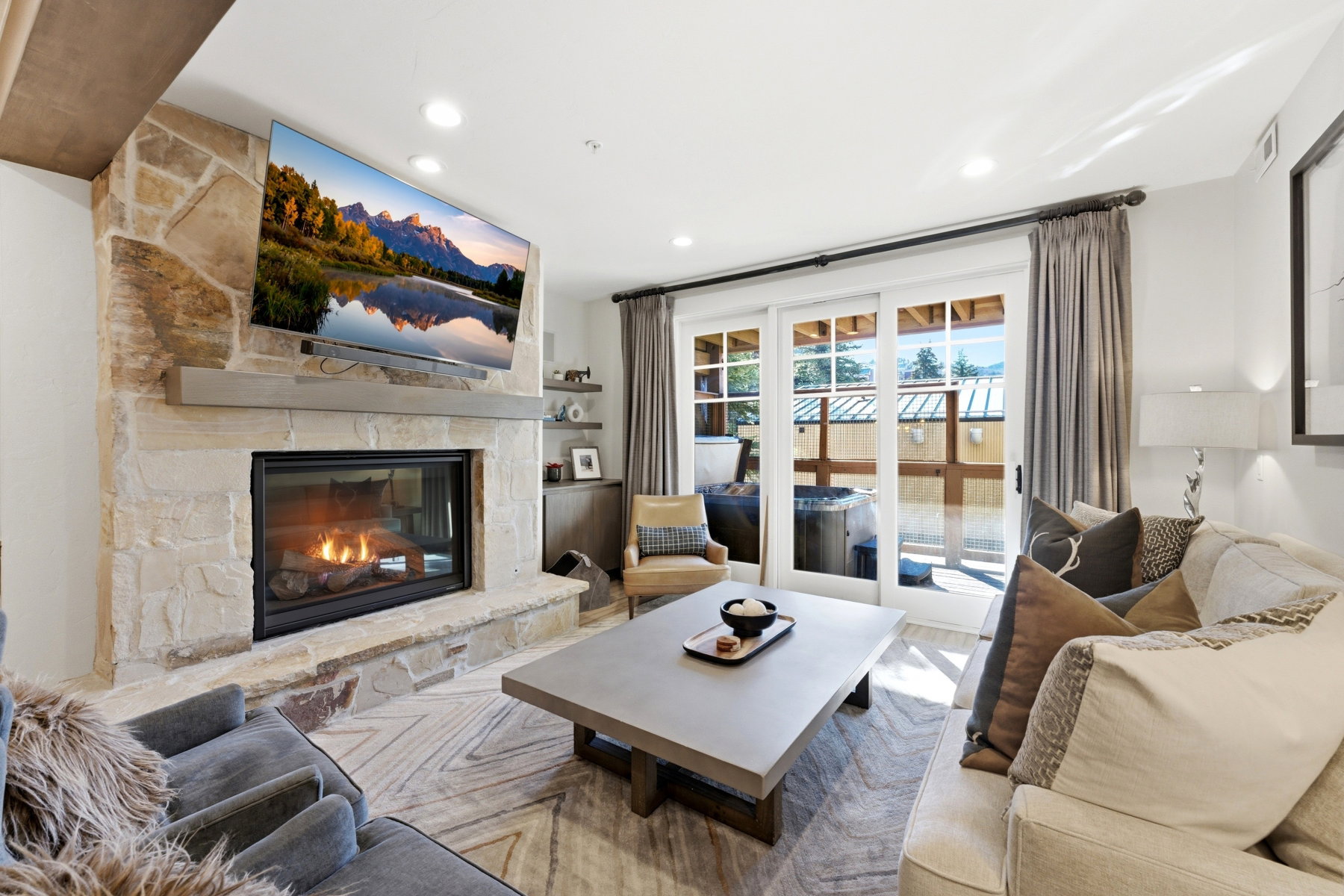 Living room featuring recessed lighting and a stone fireplace