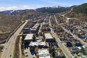 Aerial view of property and surrounding area featuring mountains