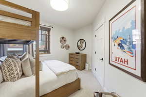 Bedroom featuring light carpet and baseboards