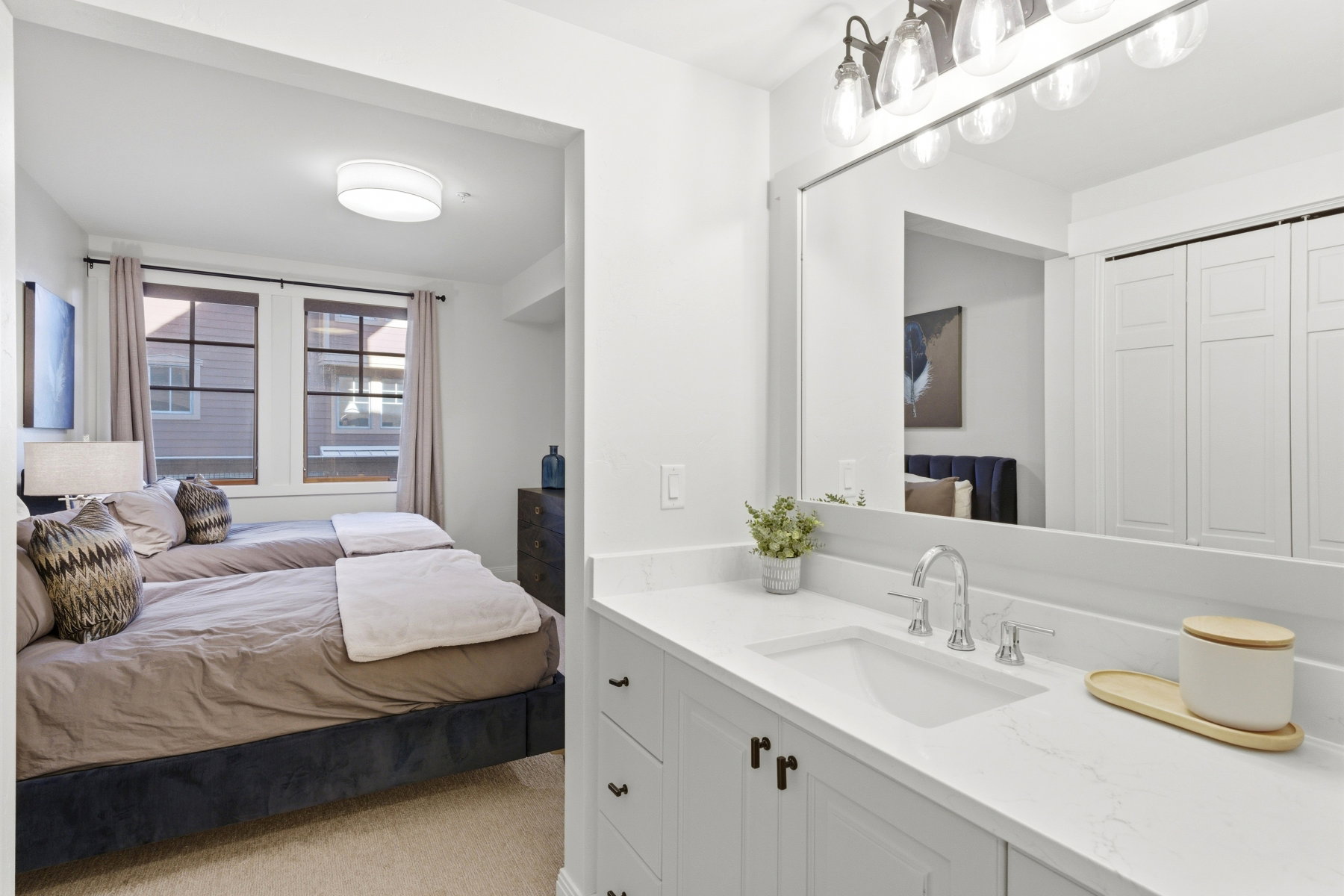 Bedroom featuring a sink and light colored carpet