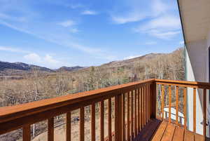Wooden deck featuring a mountain view