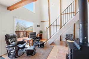 Living area featuring a wood stove, light wood-style floors, and healthy amount of natural light