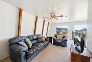Living area with carpet flooring and a ceiling fan