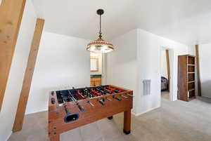 Playroom with light carpet and heating unit