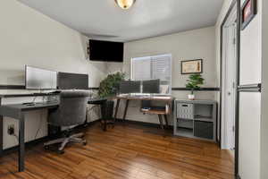 Home office with light wood-type flooring and baseboards