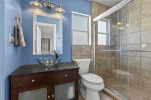 Full bath with vanity and a shower stall