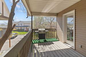 Wooden terrace featuring a grill