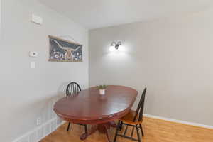 Dining space with light wood-style floors